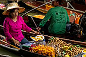 Thailand, Locals sell fruits, food and products at Damnoen Saduak floating market near Bangkok 